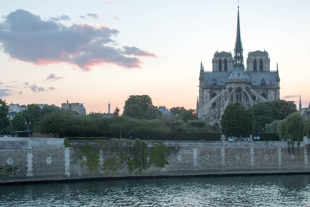 sunset over notre dame in paris, france by everyday parisian