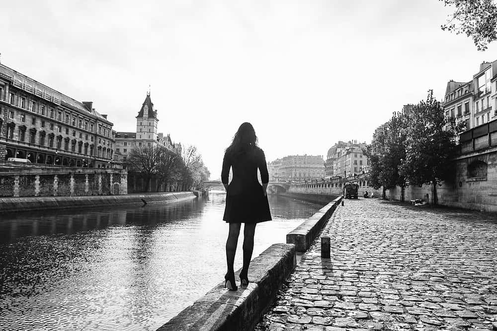 woman walking near a river returning to paris 