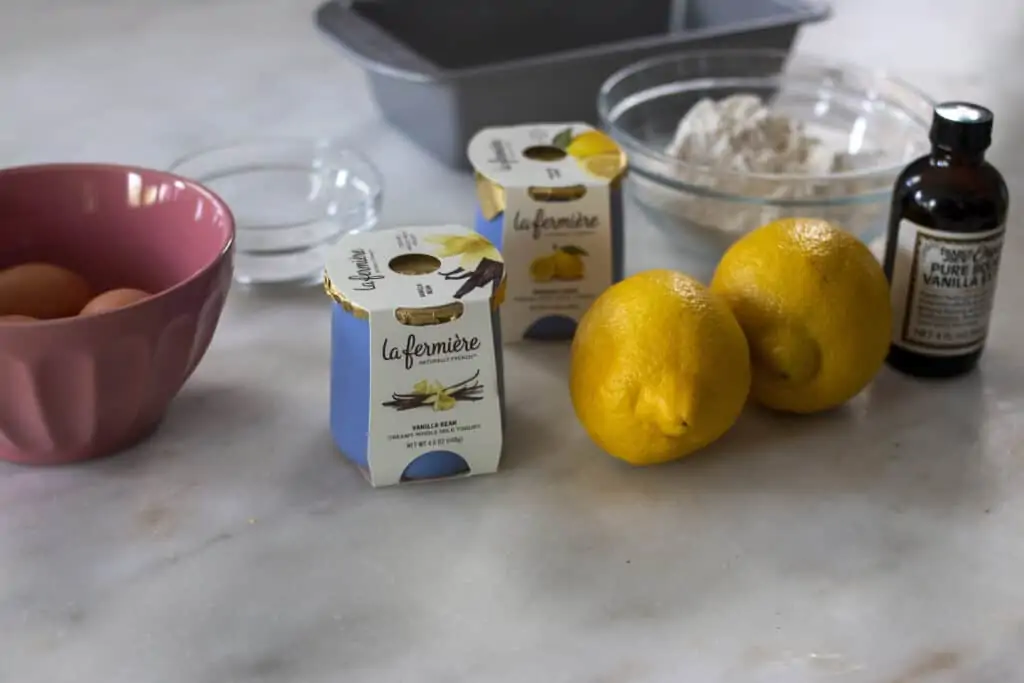 ingredients for Lemon Yogurt Cake including yogurt, eggs, lemon, and flour