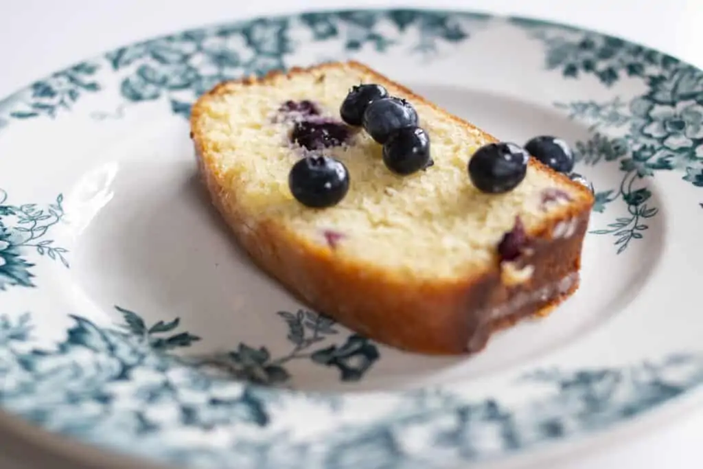 a slice of lemon yogurt cake with blueberries on top