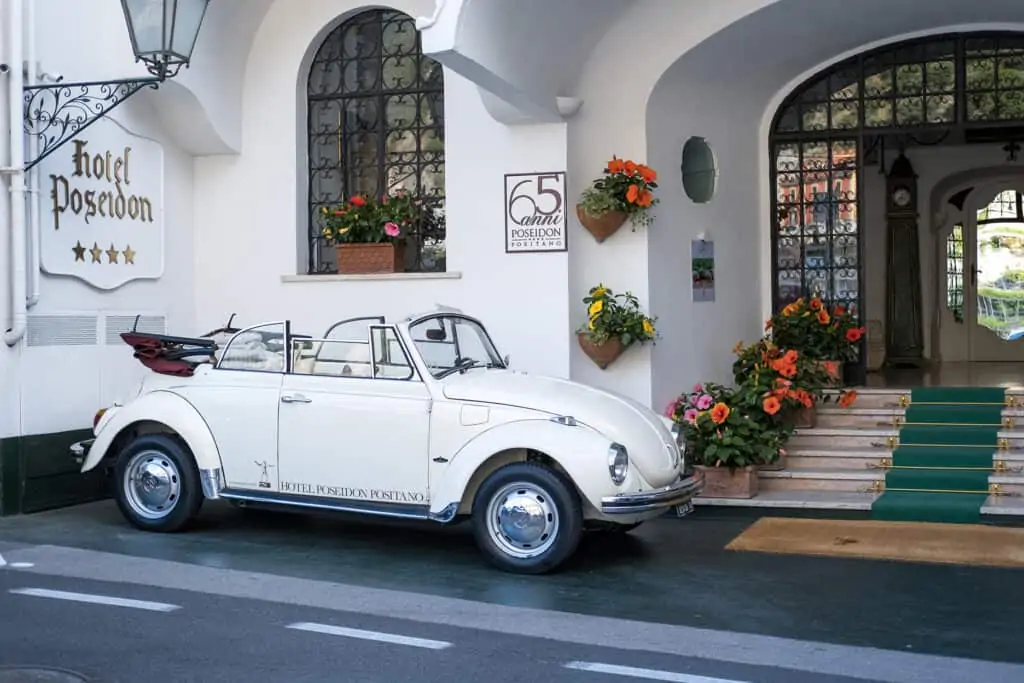 white car outside the hotel poseidon