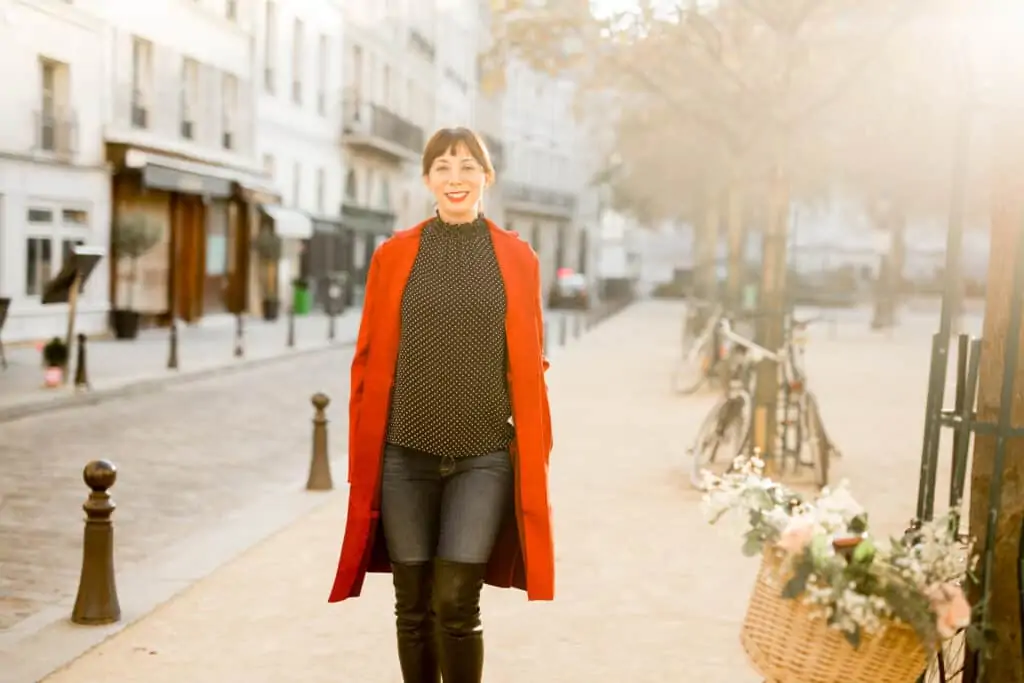 woman smiling and sharing what to pack to paris this fall 