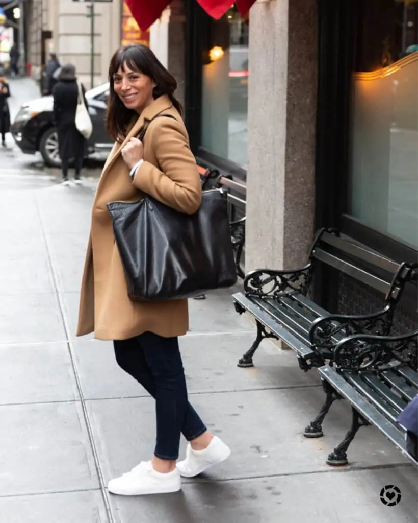 woman wearing coat and sharing what to pack in Paris for fall