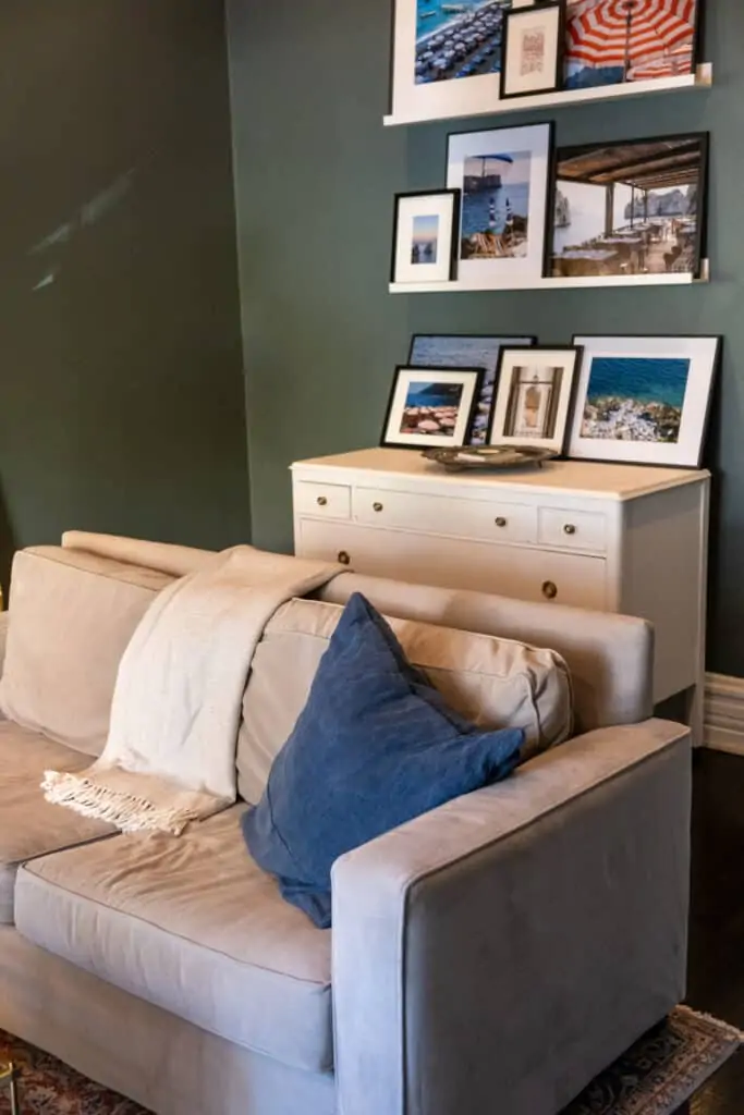 living room with sofa and framed photos