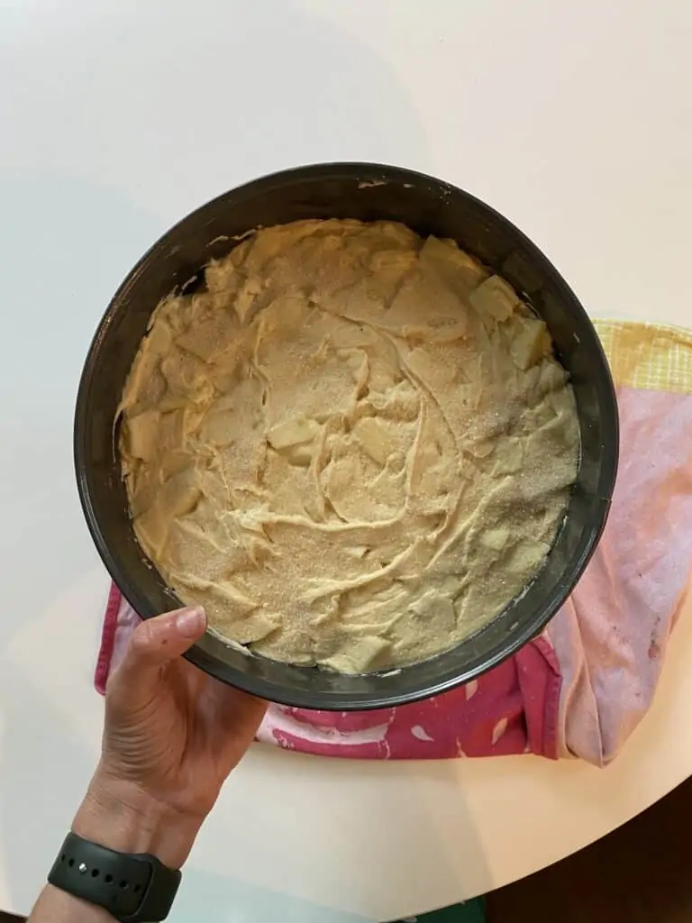 person holding a pan with raw cake ingredients