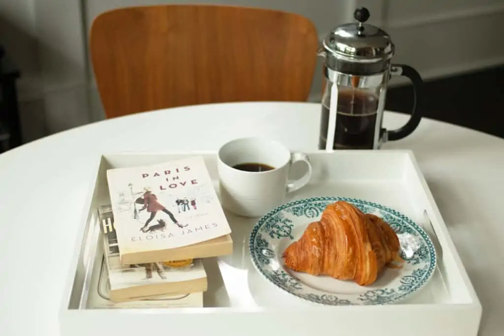 French breakfast with croissant, berries, jam and black coffee