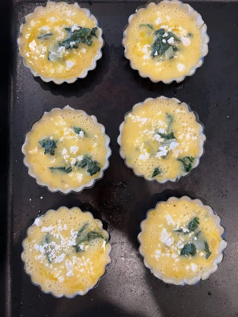 Quiche batter in mini tart pans