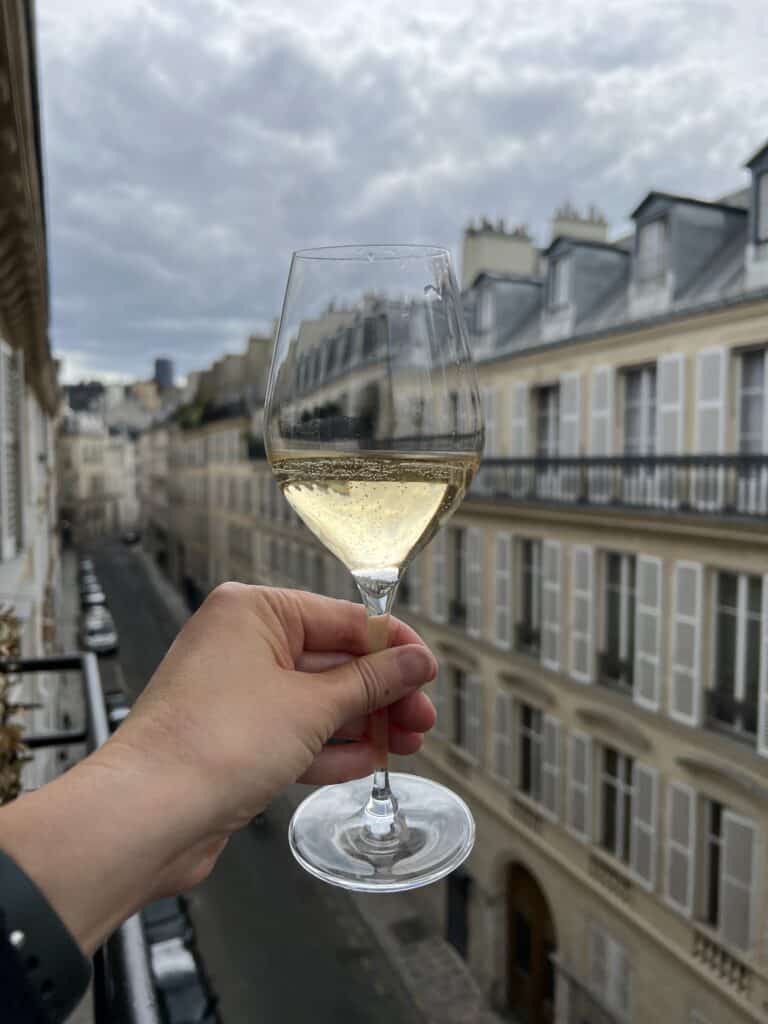 Holding a glass of champagne in hotel balcony