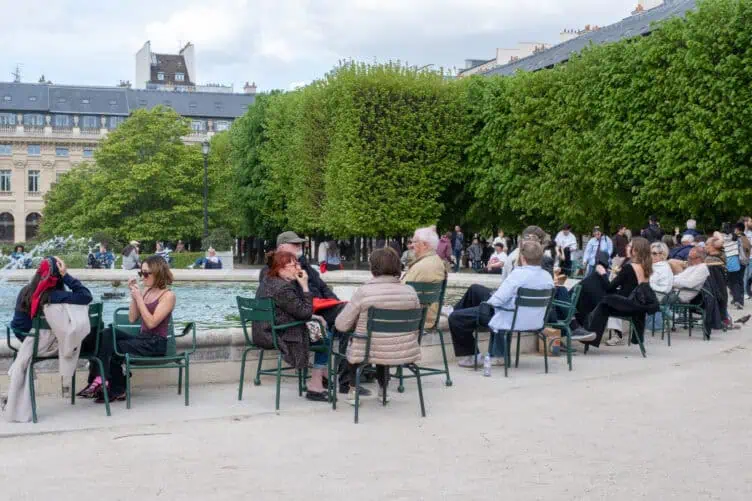 Parisians enjoying a picnic in Palais Royal around the fountain