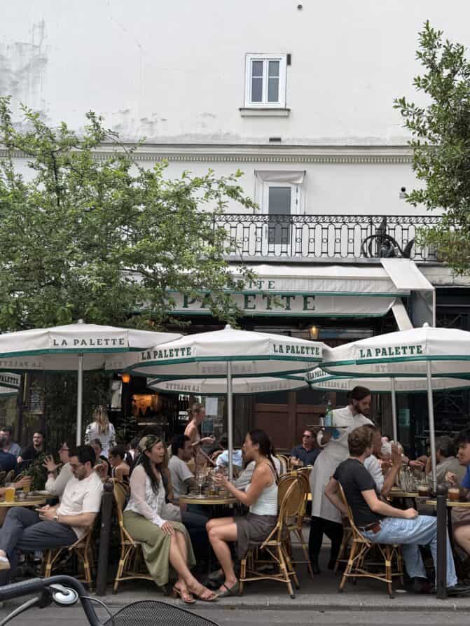 paris heat wave Parisians wearing scarves and under umbrellas at Parisian terraces